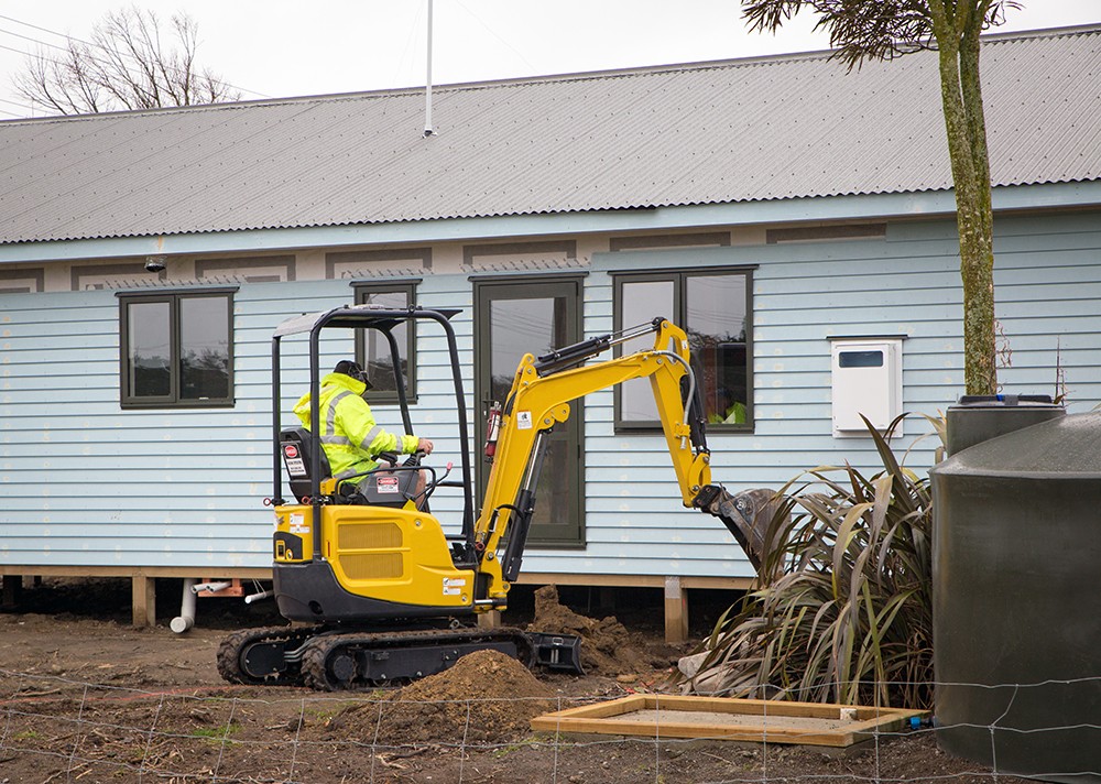 A Man Operating A Small Excavator